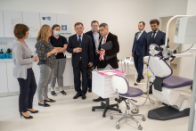 A group of people look at equipment in a very modern dental practice.