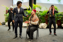 Syrian-Palestinian group,. Four men singing. One in traditional dress, one wearing an "arafat "headscarf.