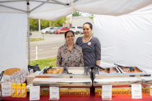 Two women at the food stand.