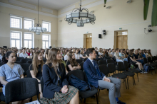 The lecture hall filled with high school students.