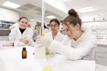 Young people in medical aprons conduct tests in the lab,