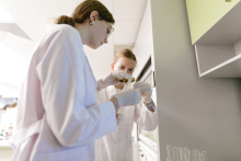 Young people in medical aprons conduct tests in the lab