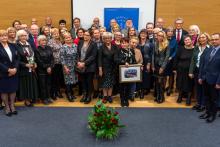 A large group of people pose for a joint photo.