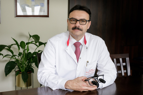 A doctor who has transplanted hearts into children. He sits at his desk, telescope glasses in his hand